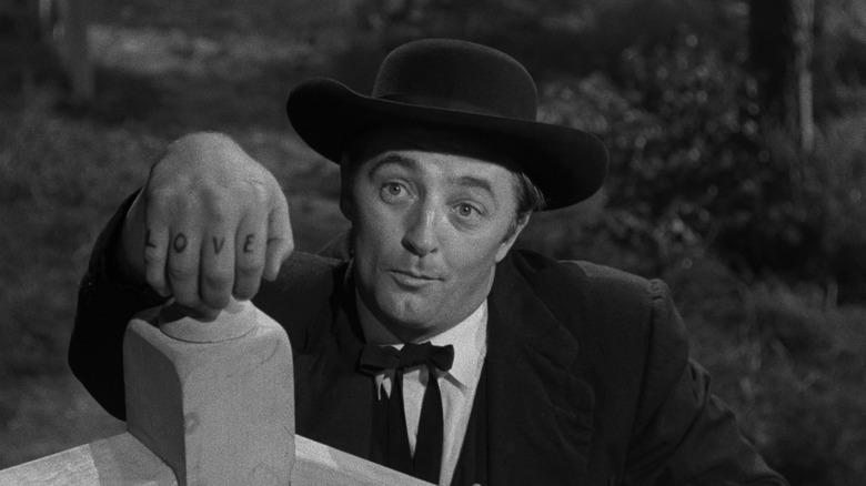 Harry Powell shows off his tattoos in The Night of the Hunter