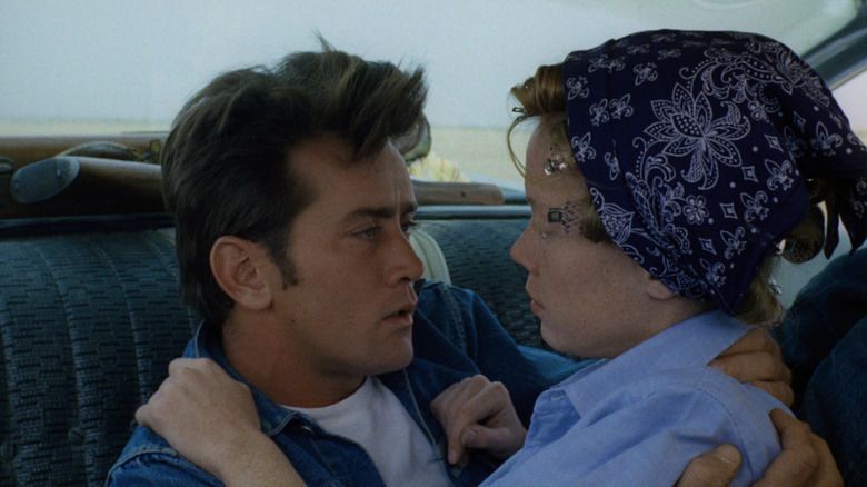 Kit and Holly sit in a car in Badlands