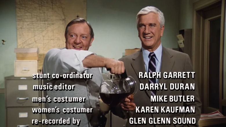 Ed Hocken (Alan North) pouring coffee on Frank Drebin's (Leslie Nielsen) hand while frozen in Police Squad