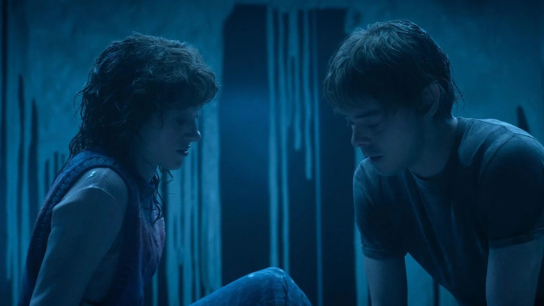 Nancy and Jonathan sitting in a dark room on Stranger Things