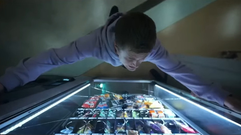 Bobby stands in front of the sales machine in the final destination: blood lines