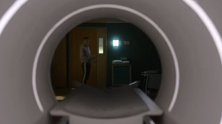 Bobby stands in front of the active MRI machine