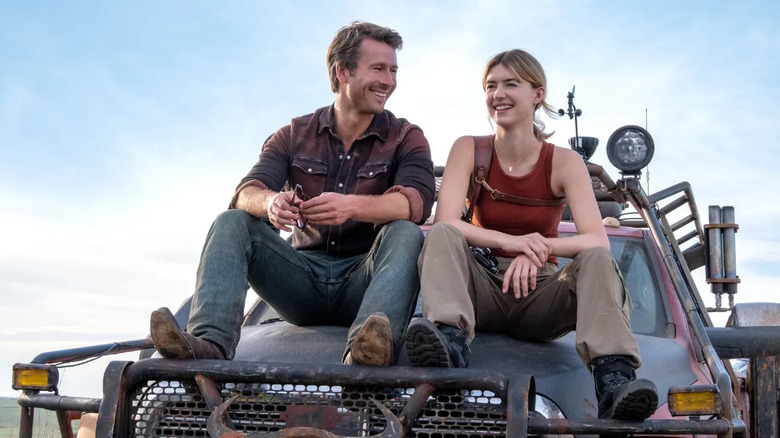 Tyler and Kate sit on the truck chasing in the storm