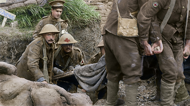 Injured soldiers being taken away by medics in They Shall Not Grow Old