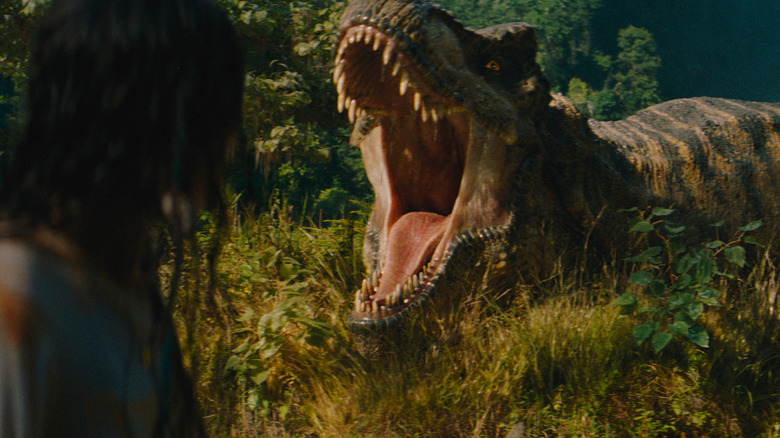 Luna Blaise as Teresa Delgado watching as a T-Rex roars in Jurassic World Rebirth