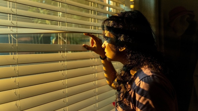 Belinda looking out the window at a spaceship outside her house on Doctor Who