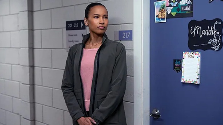 Fola Evans-Akingbola stands guard outside Maddie's bedroom as Chelsea Arrington in The Night Agent