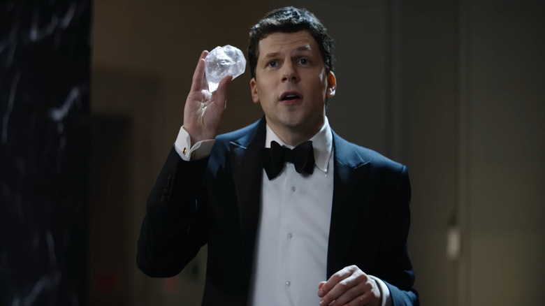 Jesse Eisenberg as J. Daniel Atlas holding a big diamond in Now You See Me: Now You Don't