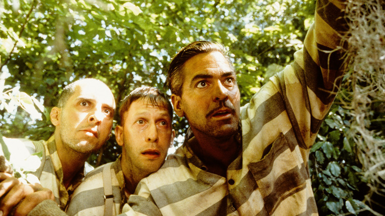 Pete Delmar and Ulysses in their prison uniforms in a forest in O Brother Where Art Thou