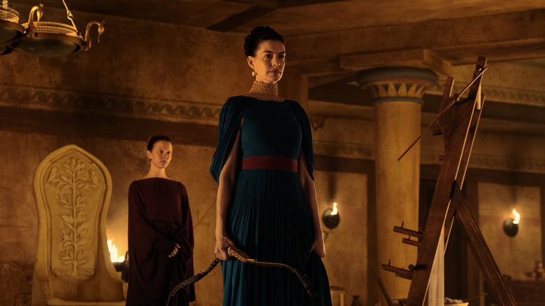 Melantho and Penelope stand in the palace in The Odyssey