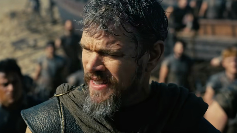 Matt Damon as Odysseus grimacing in the sunlight in The Odyssey (2026)