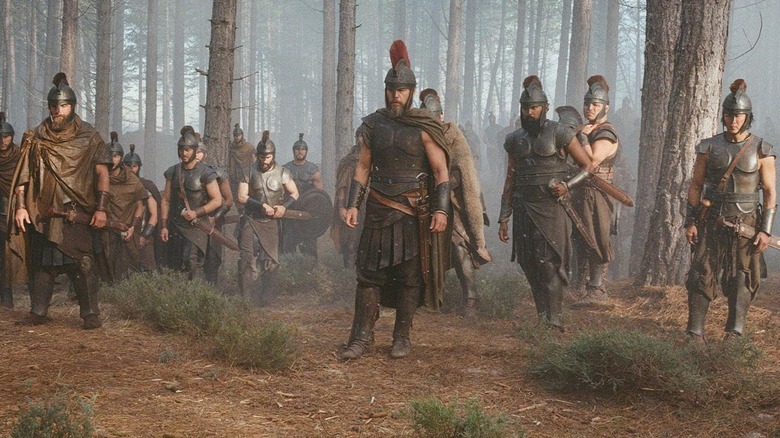 Greek soldiers led by Odysseus (Matt Damon) stand in a forest