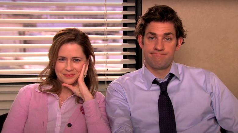 Jenna Fischer and John Krasinski talking to the camera on The Office