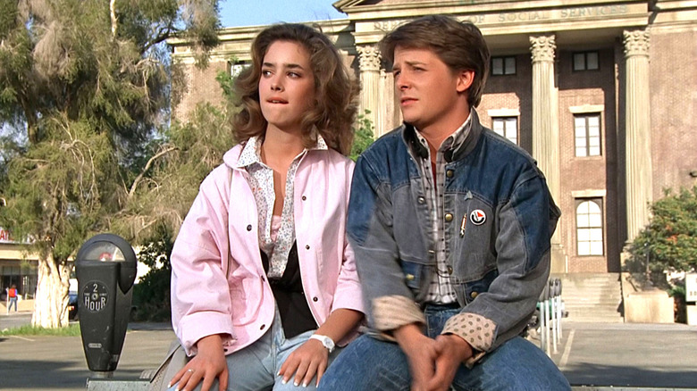 Claudia Wells as Jennifer sitting next to Michael J. Fox as Marty McFly in Back to the Future