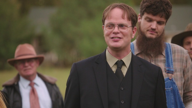 Dwight smiling and wearing a suit on the farm