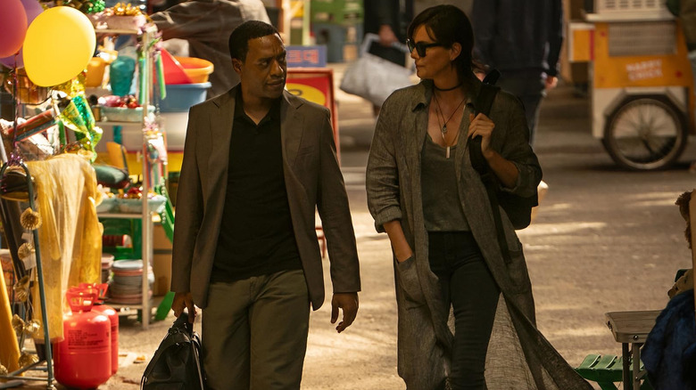 Chiwetel Ejiofor as James Copley and Charlize Theron as Andy walking in The Old Guard 2