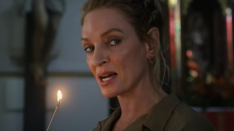 Uma Thurman as the first immortal blowing out a flame in The Old Guard 2