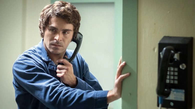 Zac Efron as Ted Bundy holding a phone to his ear in Extremely Wicked, Shockingly Evil and Vile