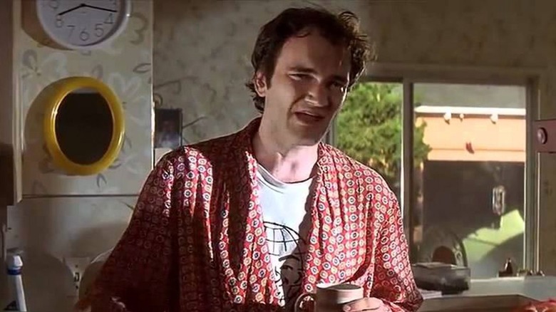 Quentin Tarantino holding a coffee cup