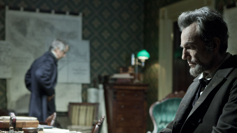 అబ్రహం లింకన్‌గా డేనియల్ డే లూయిస్ లింకన్‌లోని అతని డెస్క్‌పై చూస్తున్నాడు