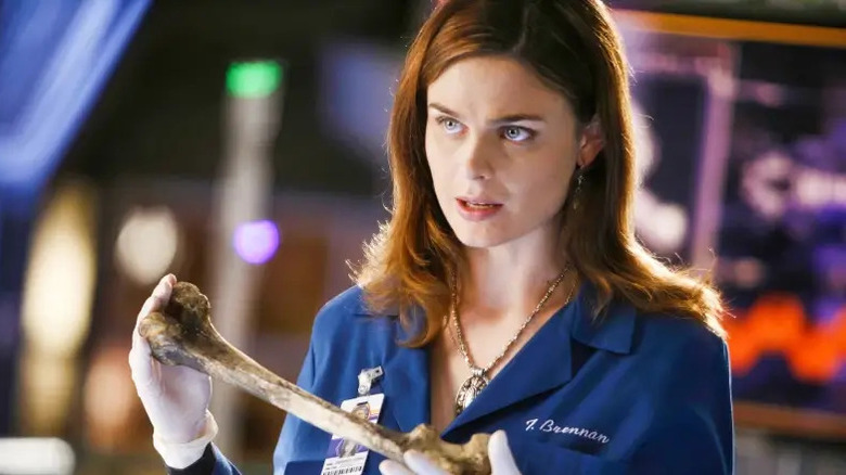 Emily Deschanel as Temperance Brennan holding a bone on Bones
