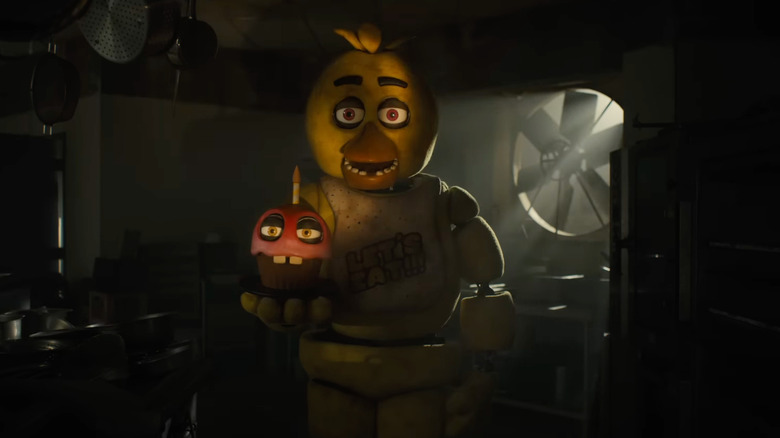 Chica holds a cupcake
