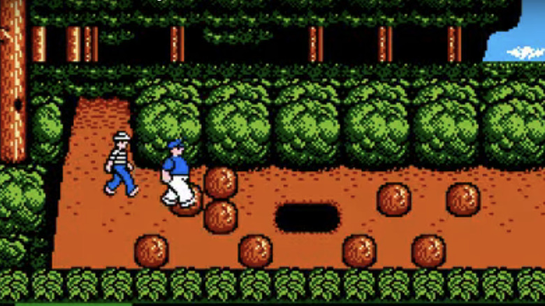Giligan follows the Skipper across a wooded level in The Adventures of Gilligan's Island video game
