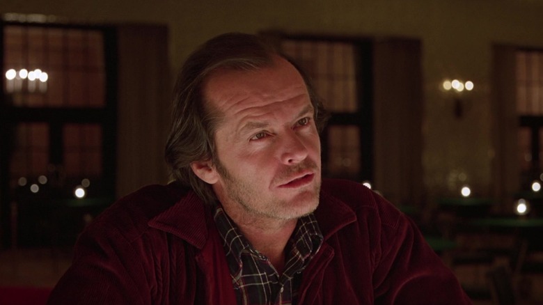 Jack Nicholson's Jack Torrance looks across frame as he sits at a bar in The Shining