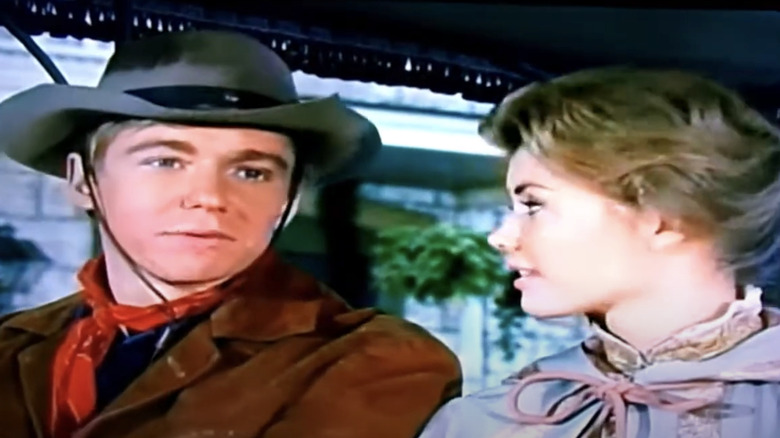 Randy Benton (Randy Boone) and Betsy Garth (Roberta Shore) talking on The Virginian