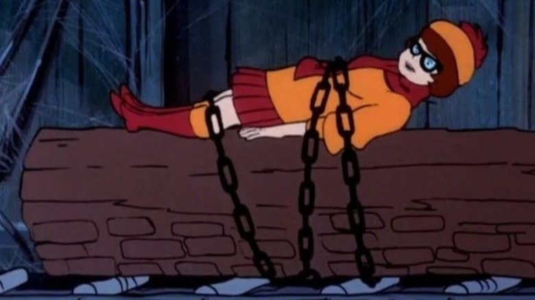 Velma chained to a log in Scooby-Doo, Where are You!