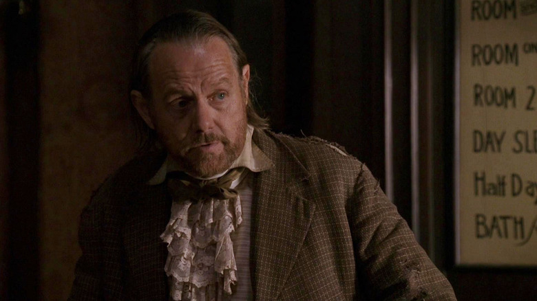 William Sanderson as E.B. Farnum wearing a suit in Deadwood
