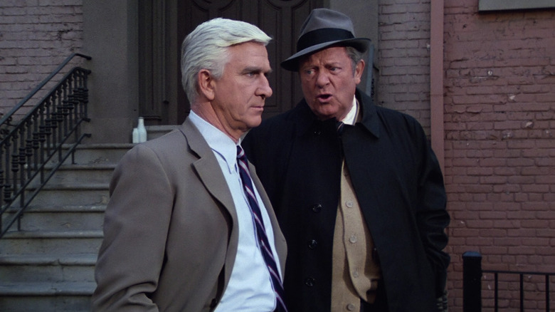 Lieutenant Frank Drebin and Captain Ed Hocken talking in the street in Police Squad!