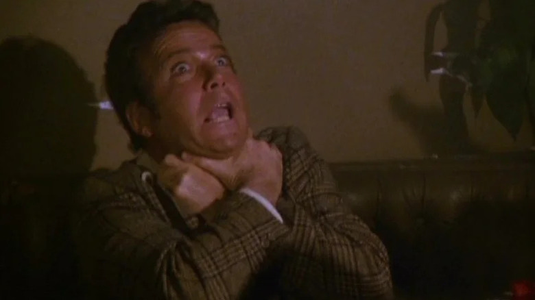 William Shatner at a dinner table, looking surprise in Police Squad!