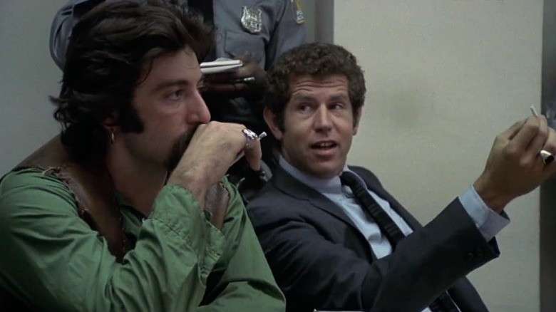 Al Pacino's Frank listening to Tony Roberts' Bob speak in a police station in Serpico