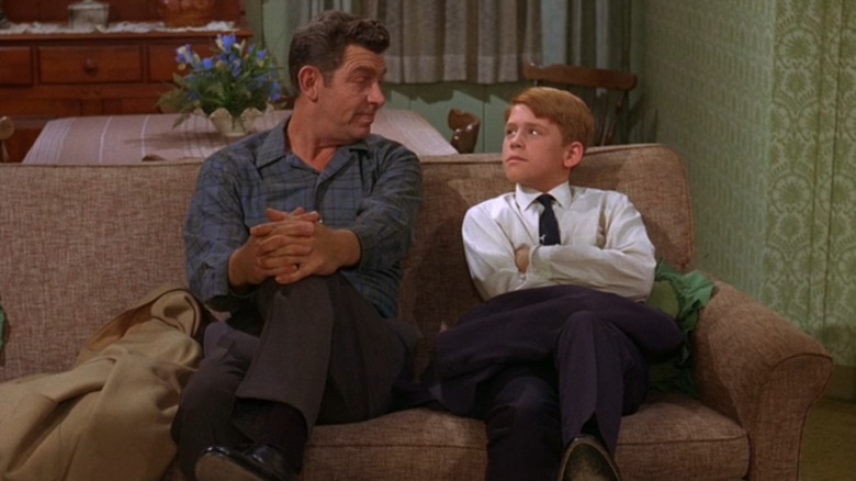 Andy Griffith sits next to Ron Howard in The Andy Griffith Show