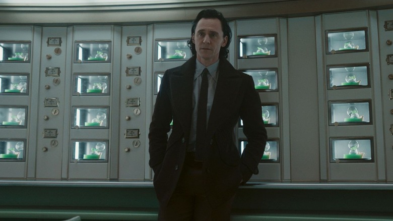 Loki stands in front of an automat stocked with pies