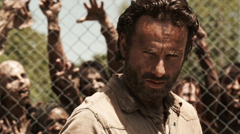 Rick Grimes surrounded by zombies on The Walking Dead