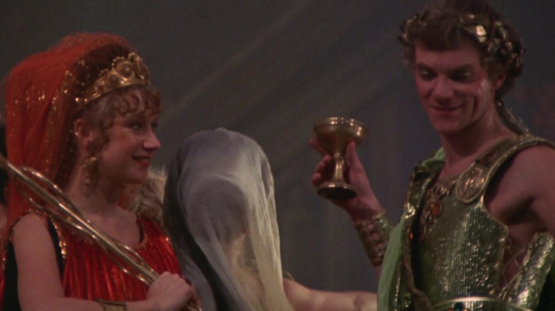 Caesonia and Caligula smiling in gaudy outfits in Caligula