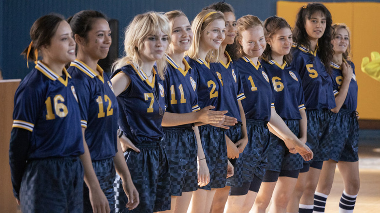 Natalie, Allie, Laura Lee, Taissa, Van, Shauna, Lottie, and Jackie in their soccer uniforms on Yellowjackets