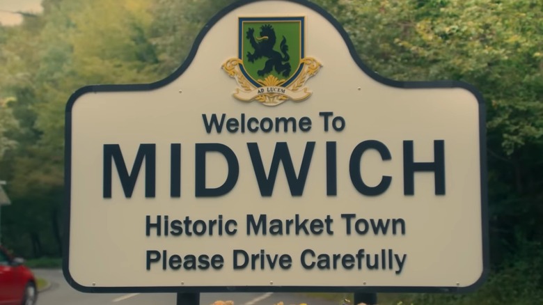 A quaint road sign that reads 'Welcome to MIDWICH, Historic Market Town, Please Drive Carefully' from The Midwich Cuckoos