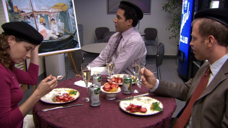 Jenna Fischer's Pam, Oscar Nuñez's Oscar, and Paul Lieberstein's Toby sit around a table during the Finer Things Club in The Office
