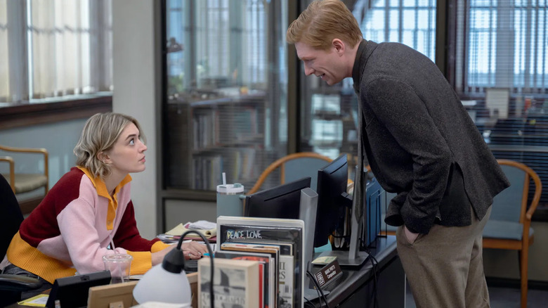 Mare and Ned talking by a desk on The Paper