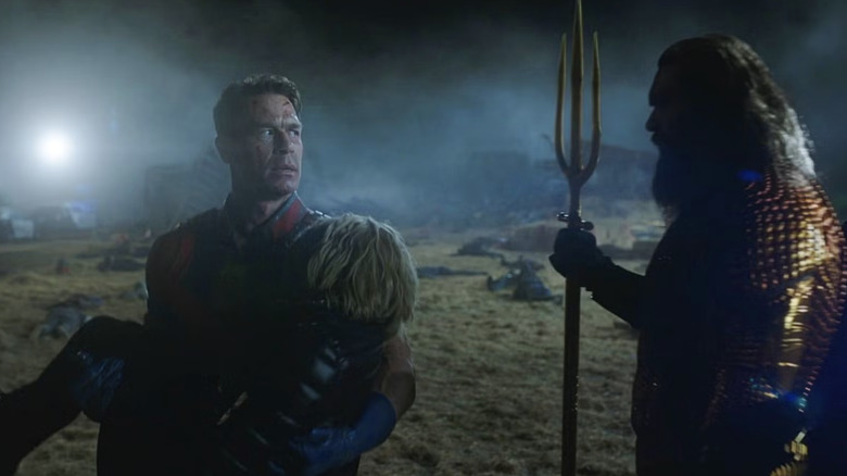Peacemaker season 1 finale: Peacemaker, carrying Harcourt, walks past Aquaman