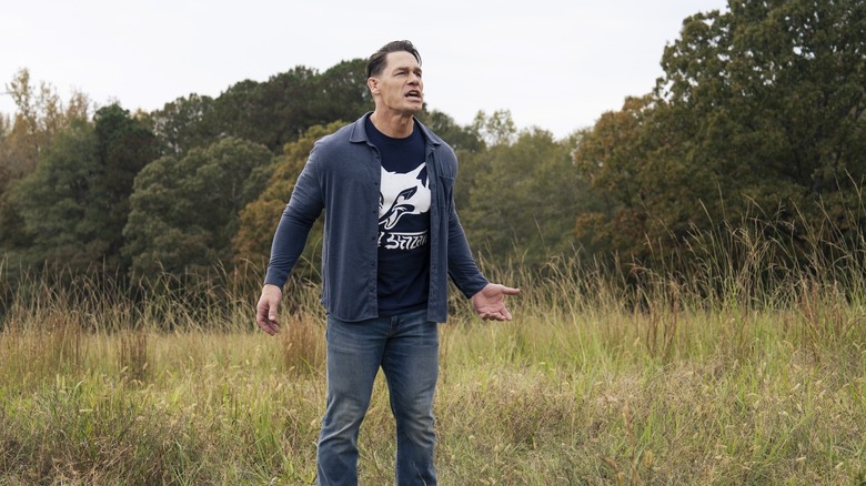 John Cena's Christopher Smith standing on a grassy field on Peacemaker
