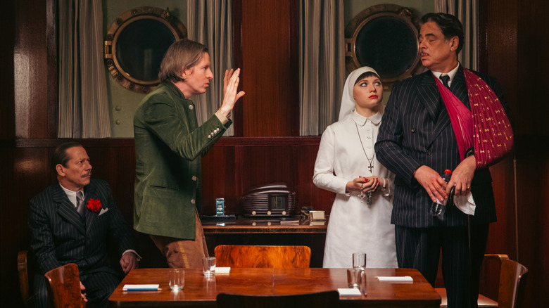 Wes Anderson directing Mathieu Amalric, Mia Threapleton, and Benicio del Toro on the set of The Phoenician Scheme
