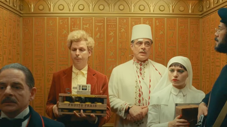 Bjørn, Korda, and Liesl notice some shady characters in the elevator of The Phoenician Scheme