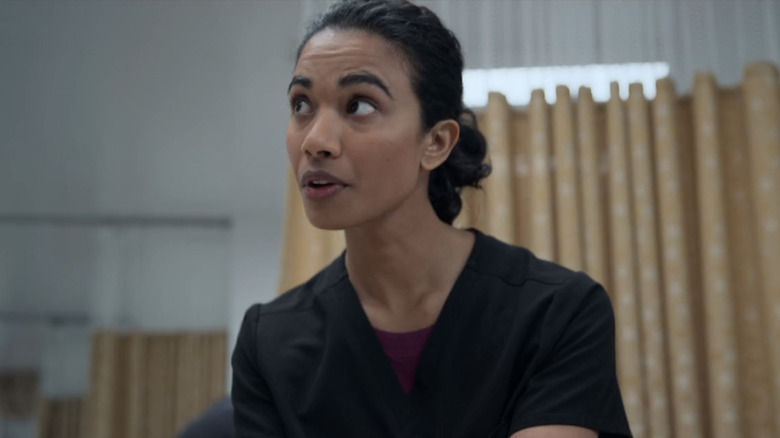 Supriya Ganesh's Dr. Samira Mohan looks worried as she looks across frame in The Pitt