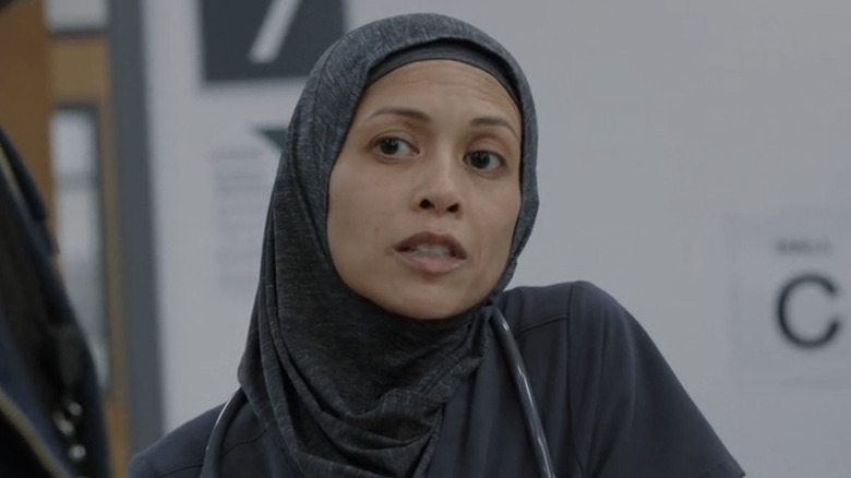Amielynn Abellera's Perlah Alawi looks across the room in The Pitt