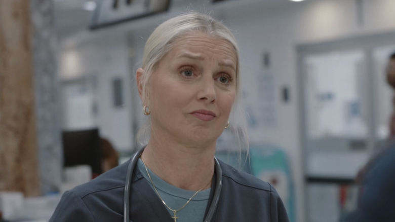 Katherine LaNasa's Dana Evans looks across frame while standing in the ER in The Pitt