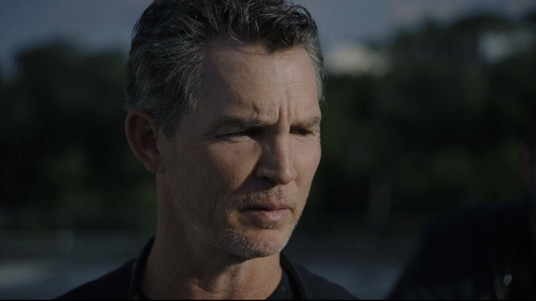 Shawn Hatosy's Dr. Jack Abbot looks off into the distance in The Pitt